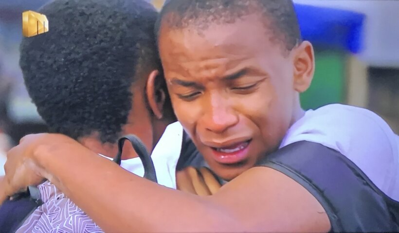 Teddy cries on Langa's shoulder